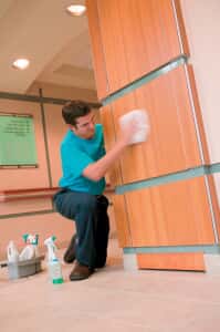 Man wiping down a wall
